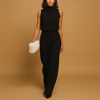 Elegant women’s jumpsuit named Sophia with halter neck, wide legs, high waist, decorative bow, and pockets. Perfect for dinners, parties, and evening wear.