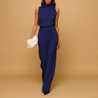 Elegant women’s jumpsuit named Sophia with halter neck, wide legs, high waist, decorative bow, and pockets. Perfect for dinners, parties, and evening wear.