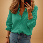 Elegant women’s blouse named Clara with subtle ruffle details, lightweight fabric, and flattering fit. Perfect for work, casual, or formal wear.