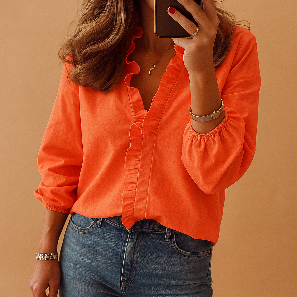 Elegant women’s blouse named Clara with subtle ruffle details, lightweight fabric, and flattering fit. Perfect for work, casual, or formal wear.