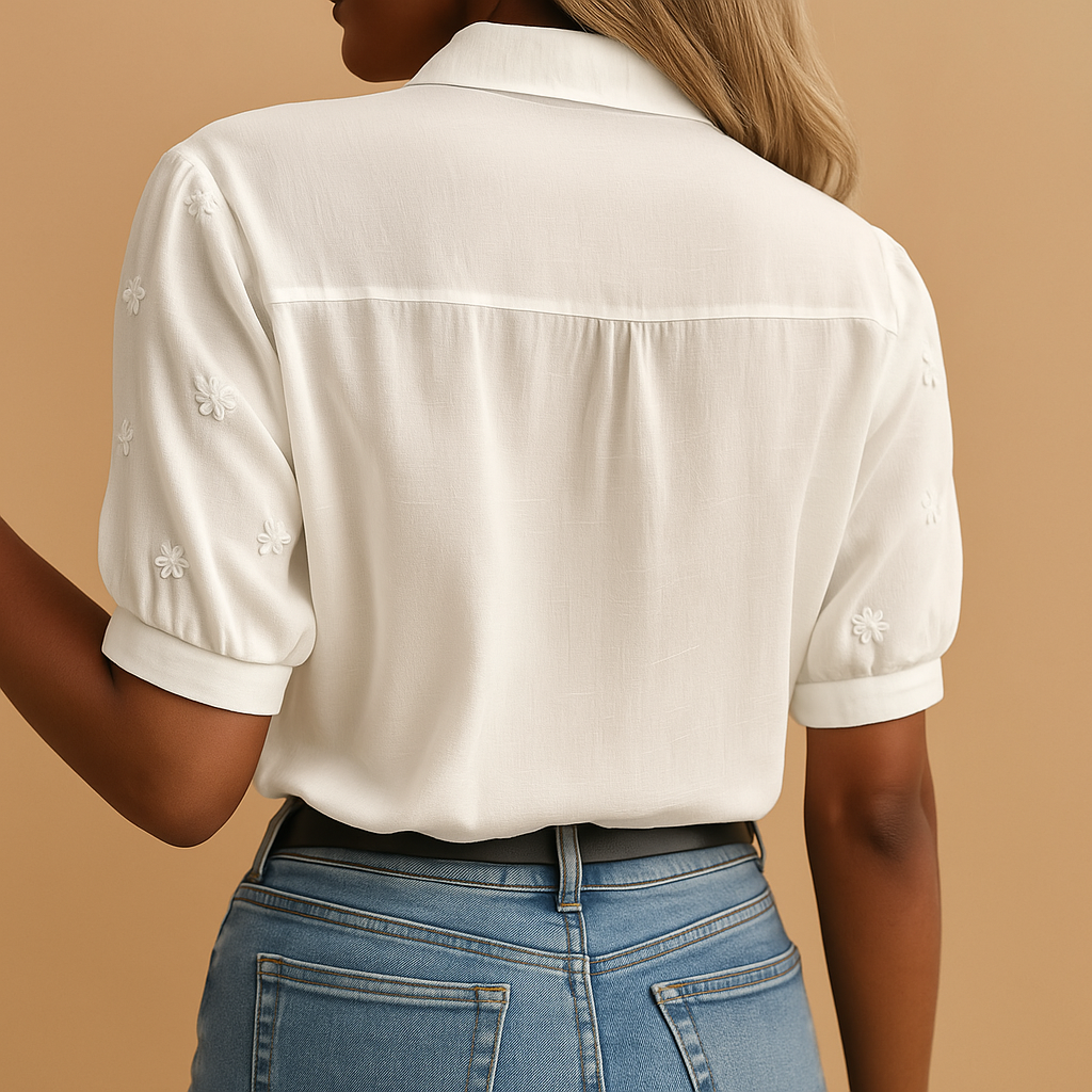 White blouse for women featuring a tailored fit, classic collar, and button closure. Ideal for work, leisure, or evening wear.