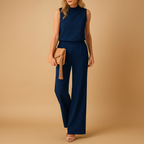 Elegant wide leg jumpsuit for women named Harper with round neckline, mid-waist fit, and flowing silhouette, available in pink, red, blue, and black.