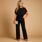 High waist jumpsuit for women named Naomi with lace-up detail, flattering fit, and flowing fabric in black, navy blue, yellow, and apricot.